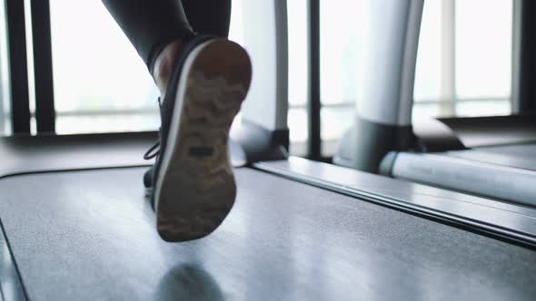 Young Fit Woman Walking on Treadmill in Gym. Cardio Training Weight Loss Concept.  Slow Motion