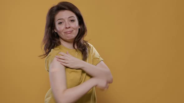 Portrait of Smiling Woman Lifting Sleeve and Showing Band Aid After Covid or Flu Vaccine for Health