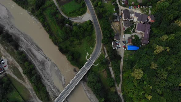 Flying over the bridge in a mountainous area.