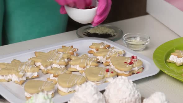 Woman Decorates Marshmallow Sandwiches With Sprinkles. Close Up Shot.