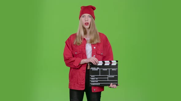 Assistant Holds a Clapperboard in the Hands. Green Screen