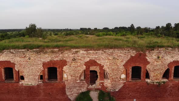 View From Above To the Dilapidated Bastion of the Ancient Fortress and River Bank with Houses and
