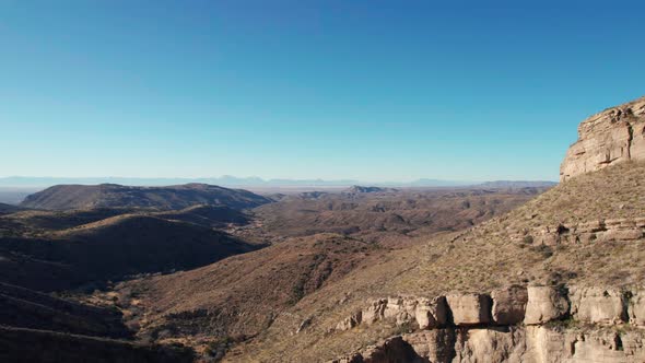 Drone aerial view revealing a large open space with rolling hills