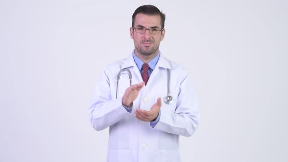 Young Happy Hispanic Man Doctor Clapping Hands