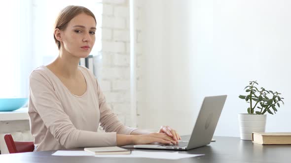 Woman Looking at Camera at Work in Loft office