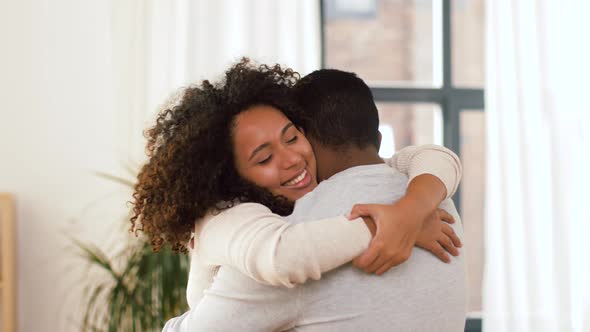 Happy African American Couple Hugging at Home