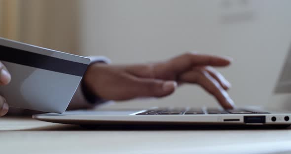 Female Hands of Afro American Woman Holding Credit Card Making e Bank Online Payment. Female