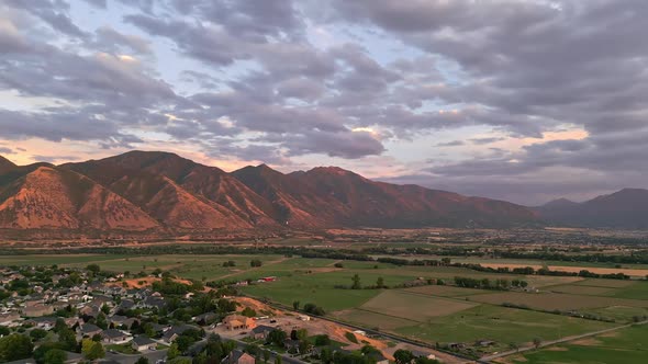 Rotating aerial view wear farmland and city meets in Spanish Fork, Utah