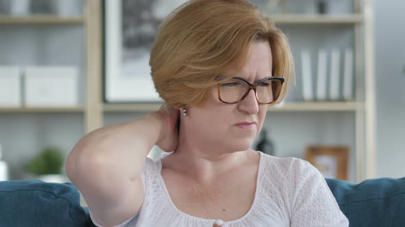 Tired Old Woman Trying to Relax Body by Stretching