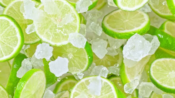 Super Slow Motion Shot of Flying Fresh Lime Slices and Crushed Ice Towards Camera at 1000Fps
