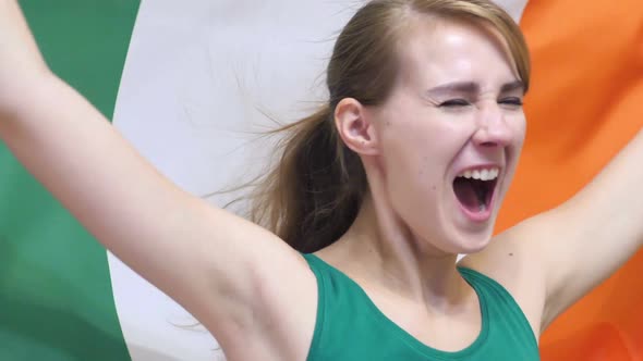 Irish Young Woman Celebrates Holding the Flag of Ireland in Slow Motion