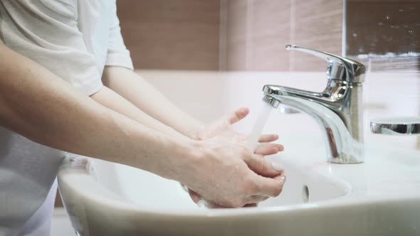 Mother with Little Son Washing Hands Together