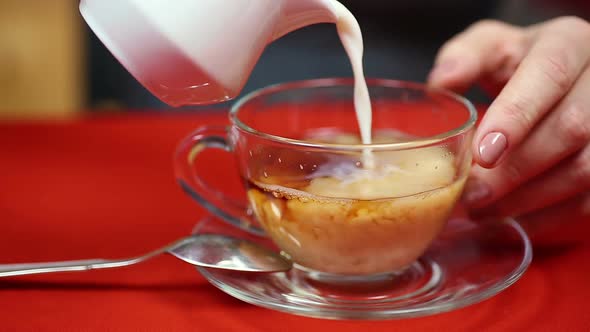 Girl Pouring Milk in Black Tea