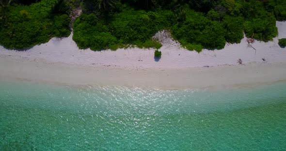 Tropical above island view of a sandy white paradise beach and aqua turquoise water background