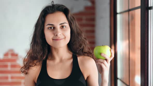 Medium Closeup Portrait of Happy Adorable Girl Holding Fresh Appetizing Green Apple