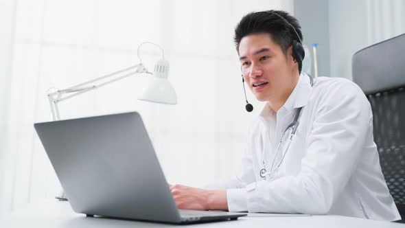 Asian male medical doctor talking virtual online with patient at home.