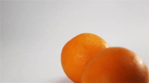Oranges Falling and Bouncing on White Wet Surface