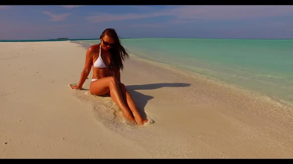 Single lady sunbathes on perfect lagoon beach wildlife by transparent ocean and white sandy backgrou