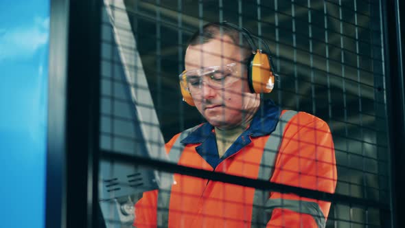 Industrial Engineer Work Filmed Through Protection Screen