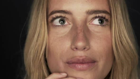 Slow motion shot of woman thinking and then looking up in surprised joy