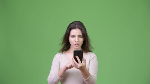Young Beautiful Woman Using Phone and Getting Bad News