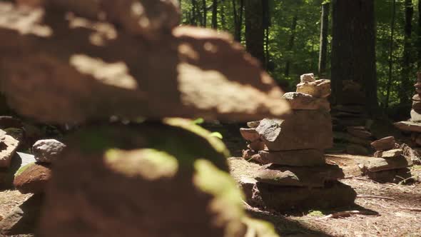 A monument of stacked stones in the woods.