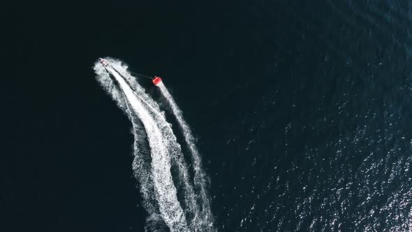 Happy People Swim on Air Mattress Behind a High Speed Water Bike