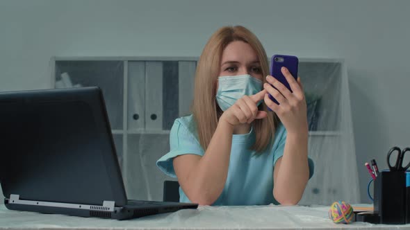 Health Protection Young Woman Office Worker in Protective Medical Mask Works in Quarantine and Uses