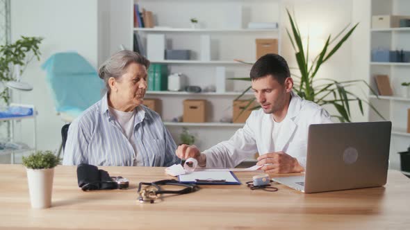 The Cardiologist Reads theECG Printout The Doctor Analyzes the Electrocardiogram