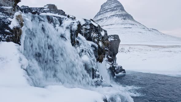 Drone Of Waterfalls And Frozen Landscape With Kirkjufell Mountain