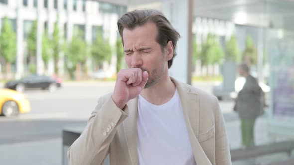 Young Man Coughing While Standing Outdoor