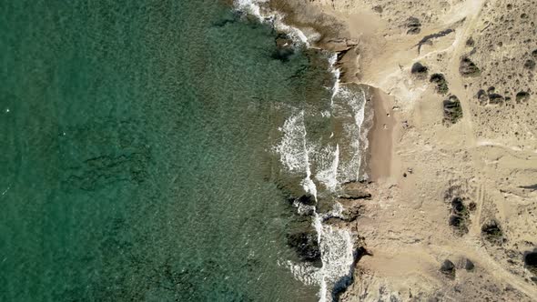 Still shot of turquoise blue waves rolling onto sandy Mediterranean coastline. Pure relaxing bliss.