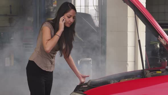 Woman having car trouble and talking on cell phone