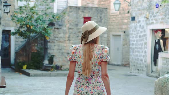 Graceful Woman Walking the Streets of a Medieval City