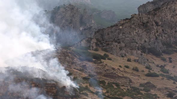 View of smoke rising as wildfire burns on mountainside in Utah alt