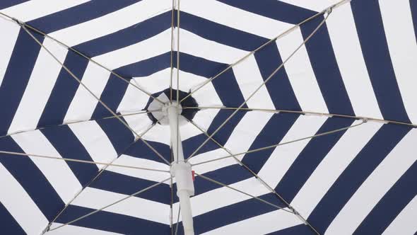 Fabric of blue umbrella protection from the sun slow-mo   moving on wind 1080p FullHD footage - Slow