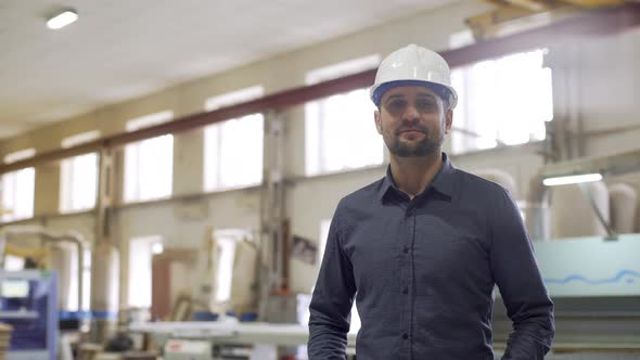 Portrait of Executive Manufacture Professional in Helmet Monitoring Process and Work on Furniture