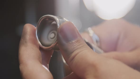 Close Up of Hands of Jeweler Polishing Ring