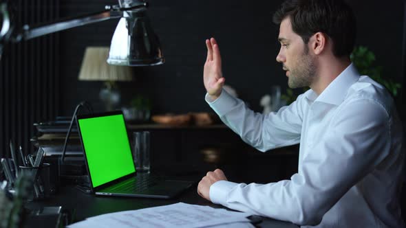 Businessman Video Calling Online on Laptop with Green Screen. Man Using Laptop