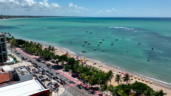 Aerial panning shot of turquoise water beach at Maceio Alagoas Brazil.