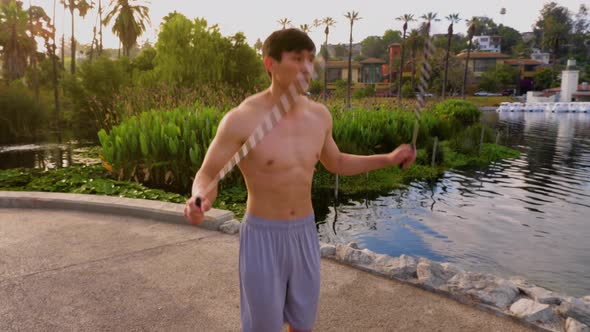 Young Asian man working out in a park in Los Angeles.