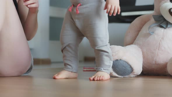 Adorable Toddler Walking Barefoot on the Floor of His Bedroom Surrounded By Toys Approaching His