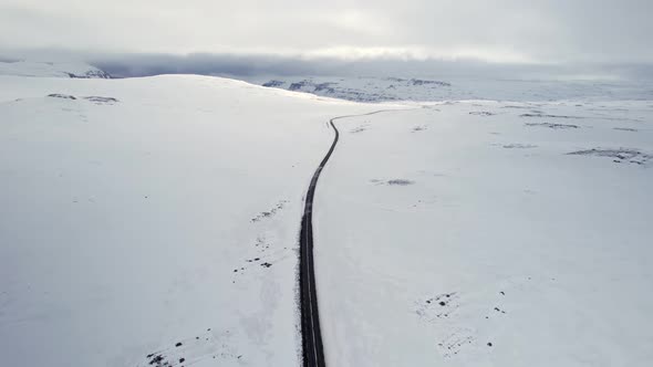 Road in the middle of a snow-covered landscape in Iceland wilderness