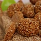 Close view of sesame seeds ladoo and sticks  placed over heap of sesame seeds - VideoHive Item for Sale