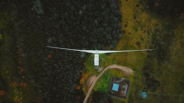 Static Top View Drone Shot, Windmill Turbine Spinning in the Middle of Green Forest, Alternative