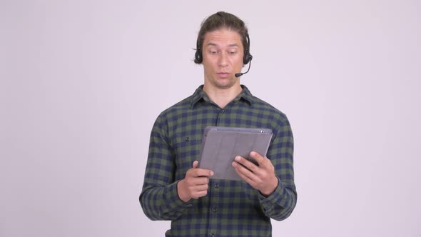 Stressed Man As Call Center Representative Using Digital Tablet
