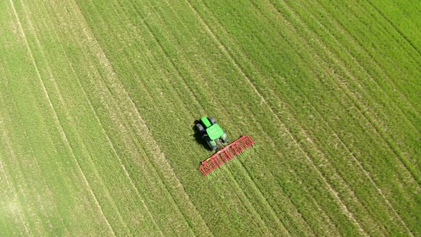 Aerial view of tractor cultivating field