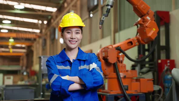 Portrait of Asian female industry worker working in factory warehouse.