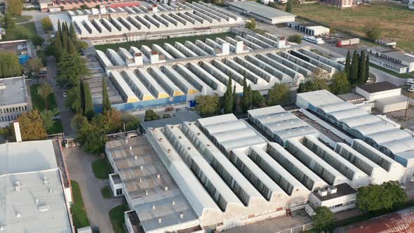 Factory buildings in an industrial park with saw-tooth roofs - business halls.