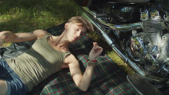 Stylish Woman Biker Fixing Motorcycle Engine